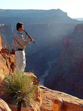 ...playing the Native American flute at the Toroweap point, Grand Canyon, Arizona
